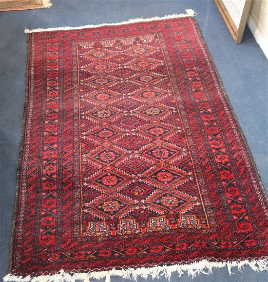 An Afghan red ground rug, 62 x 34in.